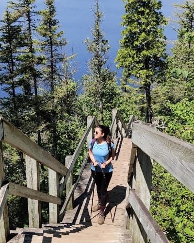 Paria hiking wooden stairs above a lake
